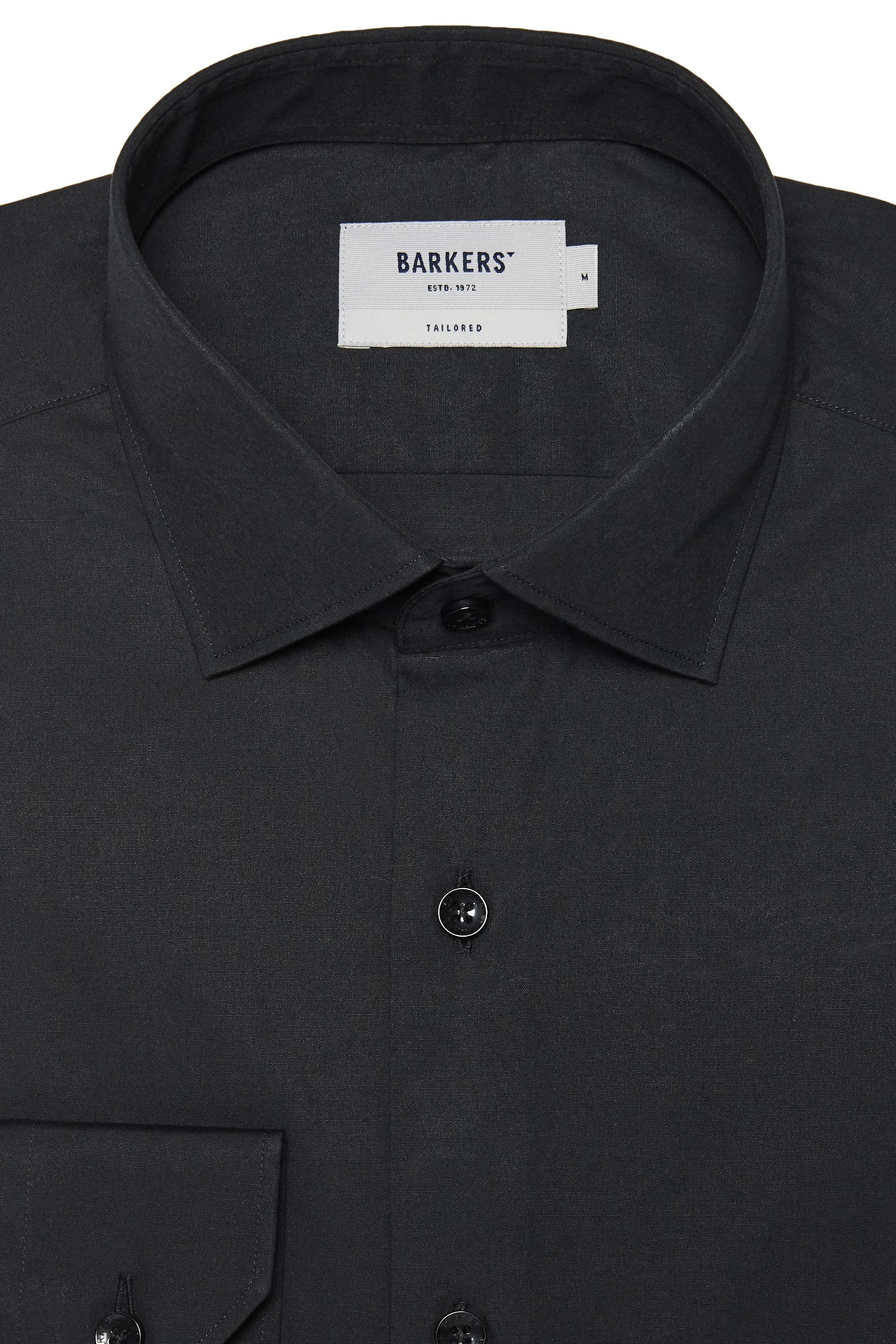 Close-up of the Barkers Tribeca Reg Cuff Shirt in black, tailored fit with front buttons. A white label inside the collar reads Barkers. Part of a left chest pocket is visible.
