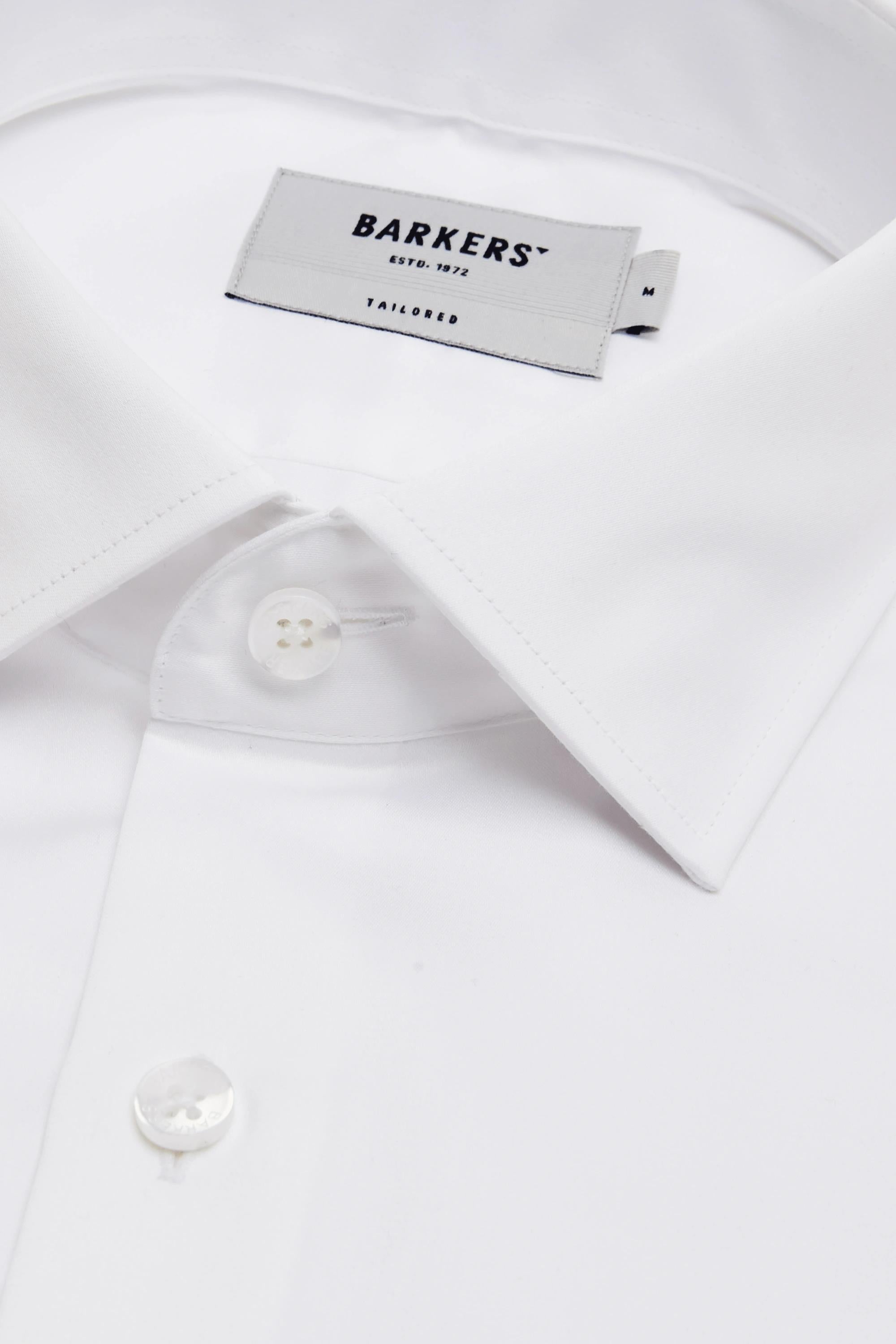 Close-up of a crisp, white Tribeca French Cuff Shirt by Barkers, featuring a tailored fit, pointed collar, white buttons, and a Barkers label inside the collar.