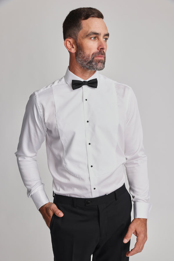 Man in Barkers Eldridge Dress Shirt, black bow tie, tuxedo bib, looking to the side.