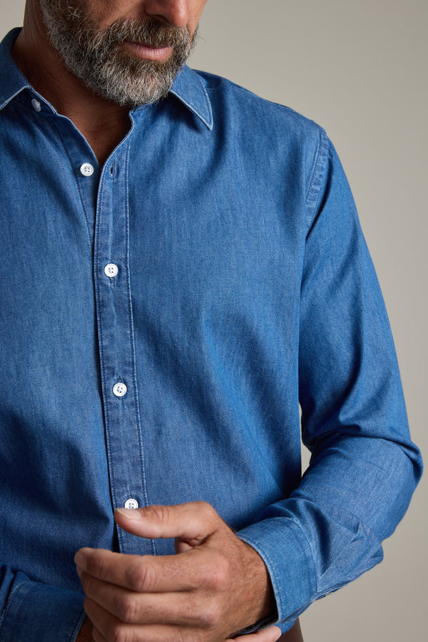 Man with a beard buttoning the cuff of his Wyatt Denim Business Shirt by Barkers.