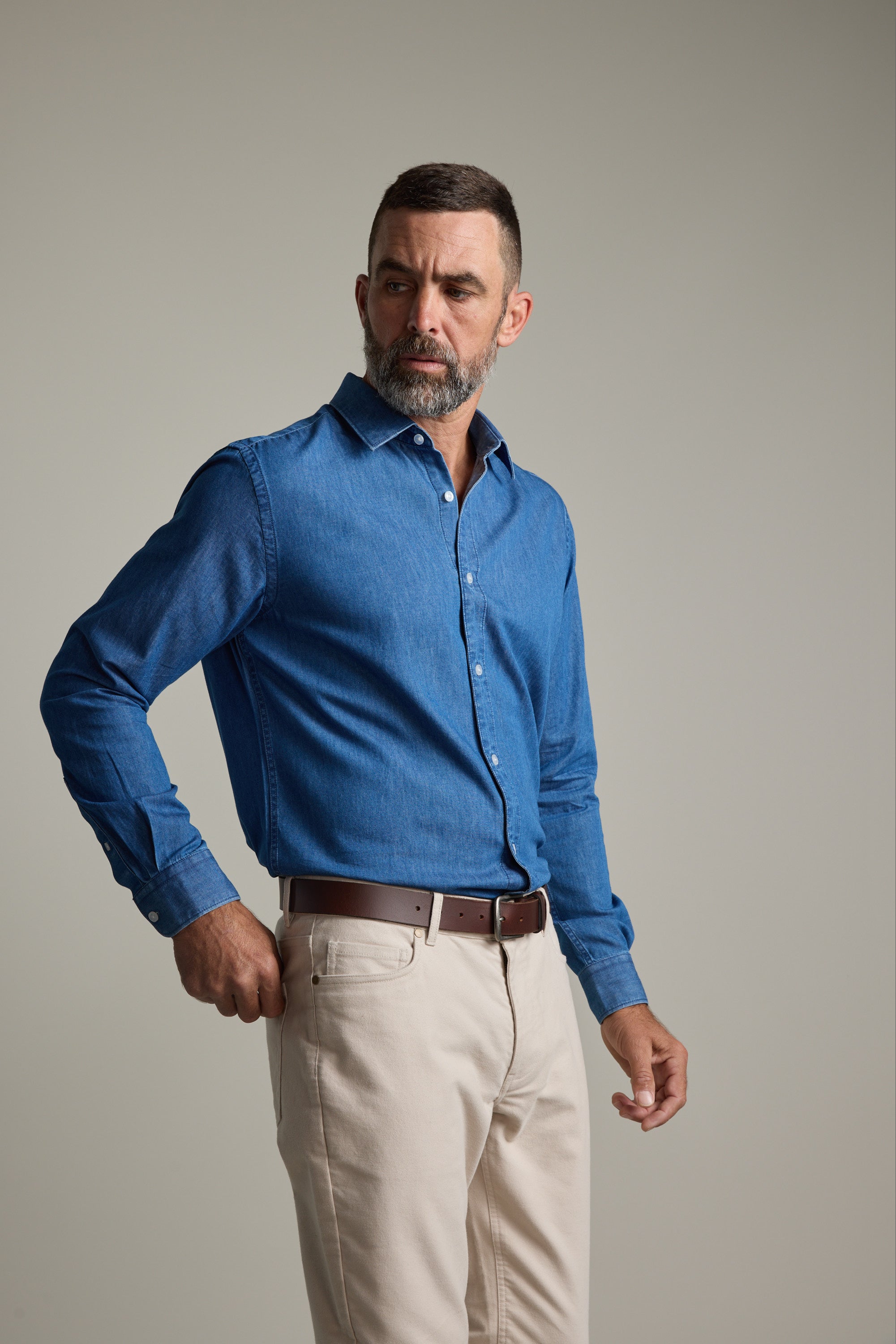 Man wears Barkers Wyatt Denim Business Shirt, eco easy care, against a plain background.