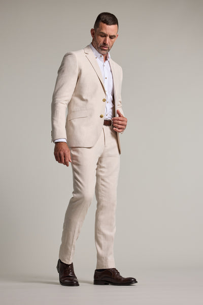 Man in Barkers Thompson Textured Linen Pant, looking down against a plain background.