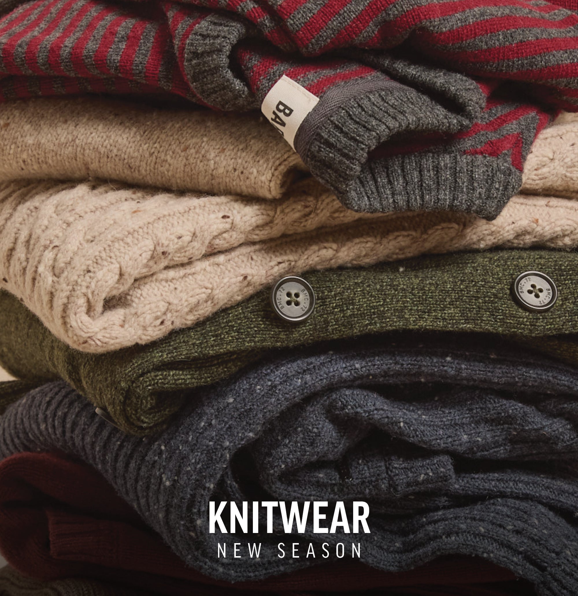 A stack of folded knit sweaters with Knitwear New Season NZ text at the bottom.