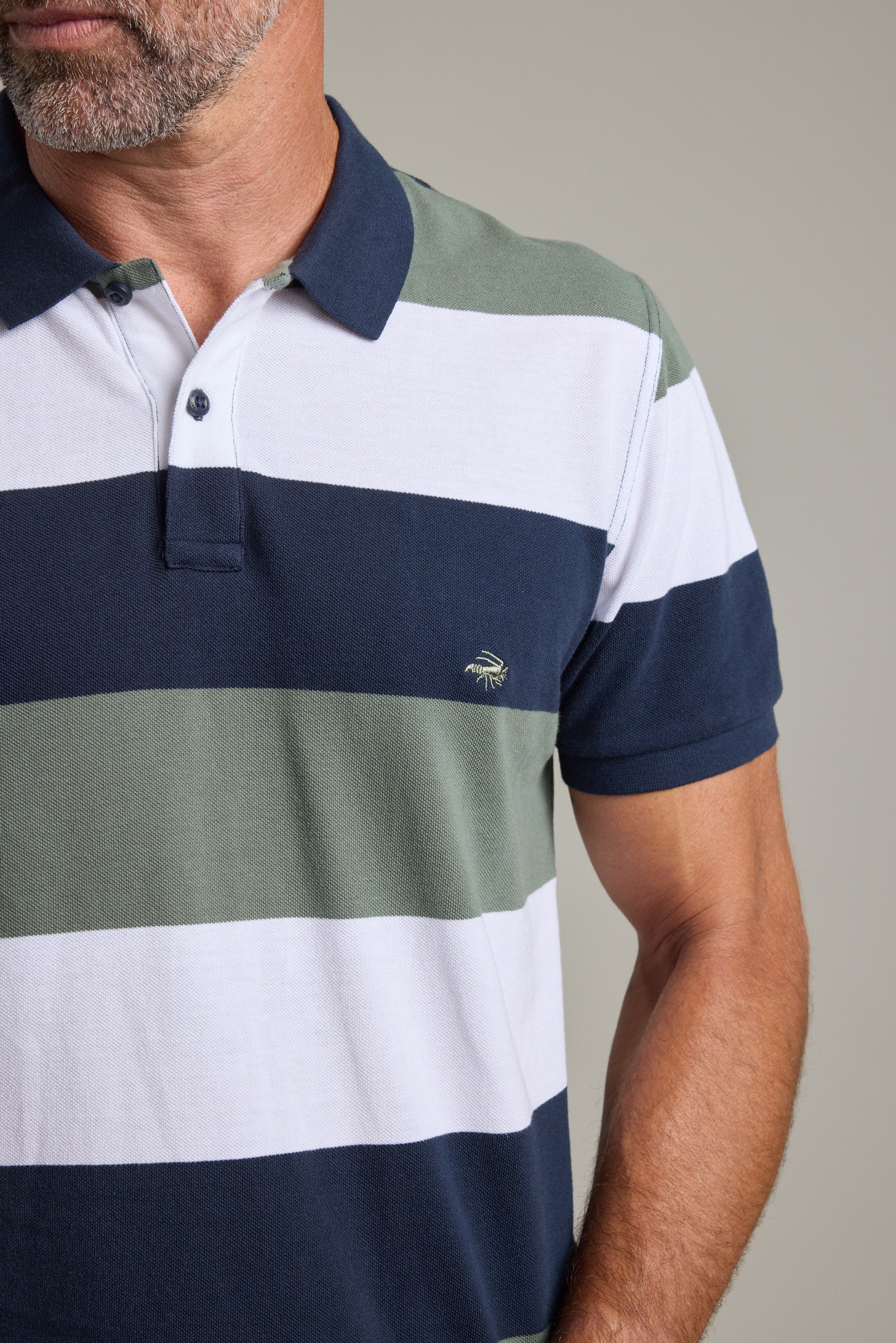 Man in Barkers Regent Pique Stripe Polo—limited edition, navy, green & white stripes.