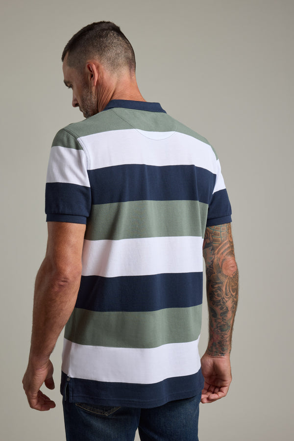 Man in Barkers Regent Pique Stripe Polo, back view, with tattooed arm and striped design.