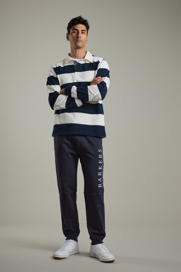 Man in Barkers Provincial Long Sleeve Rugby Jersey stands with arms crossed.