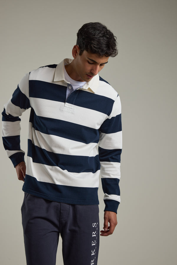 Man wears Barkers Provincial Long Sleeve Rugby Jersey in navy and white, responsibly sourced cotton.