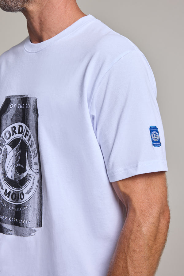 A close-up of a person wearing the Swordfish Mojo Beercan Tee by Swordfish Mojo, featuring a black and white beercan graphic on the front and a small blue patch on the left sleeve. The person's head is partially out of frame.