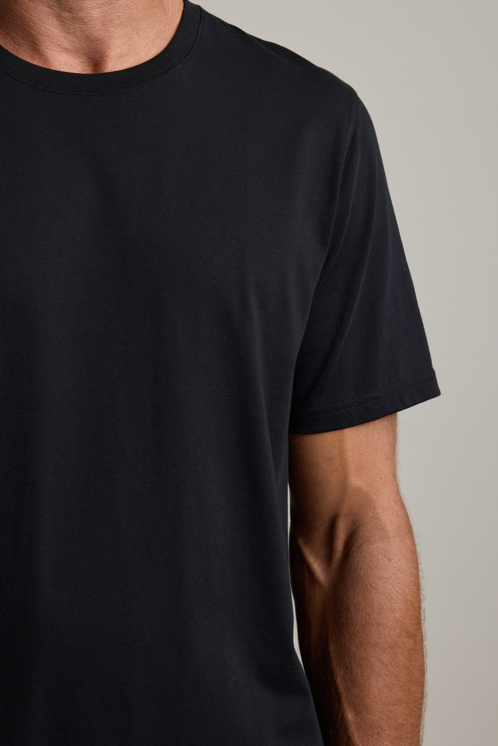 A person wears the Barkers Good Earth Cotton Essential Tee, shown shoulder to mid-torso.