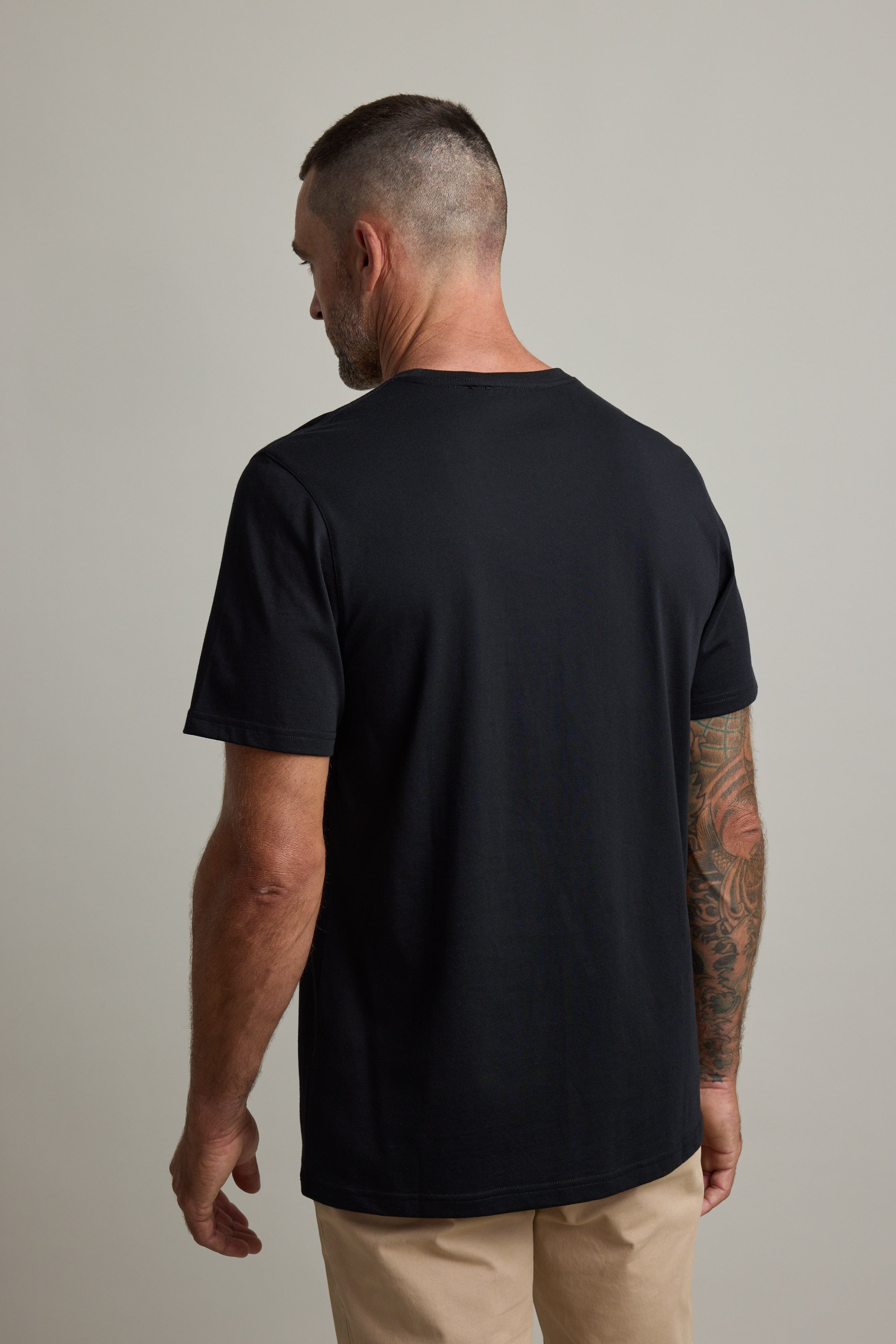 Tattooed man faces away in Barkers Good Earth Cotton Essential Tee.