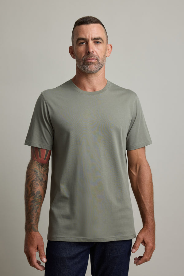 Man with tattoos wears Barkers Good Earth Cotton Essential Tee, facing forward.