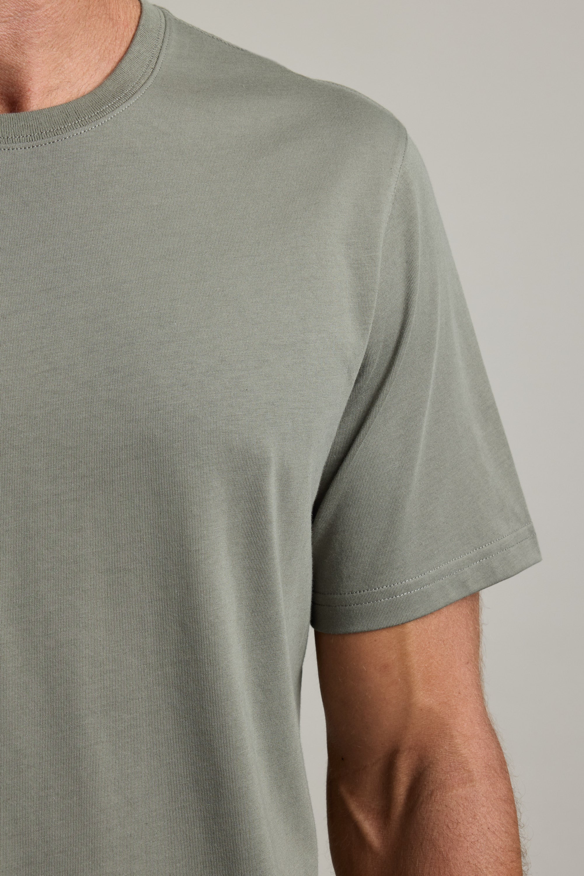 Man wearing a Barkers Good Earth Cotton Essential Tee in light gray, made from traceable cotton.