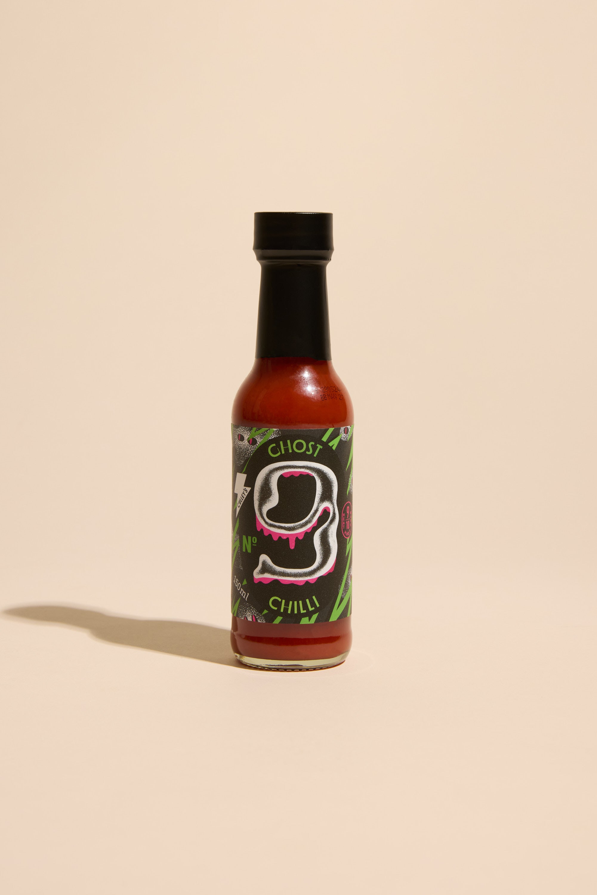 A bottle of Culley’s Bhut Jolokia Hot Sauce with a black cap stands upright on a beige surface. The label has white and pink graphics, green accents, and says Ghost Chilli and No. 1—ideal for adding heat to authentic curries.