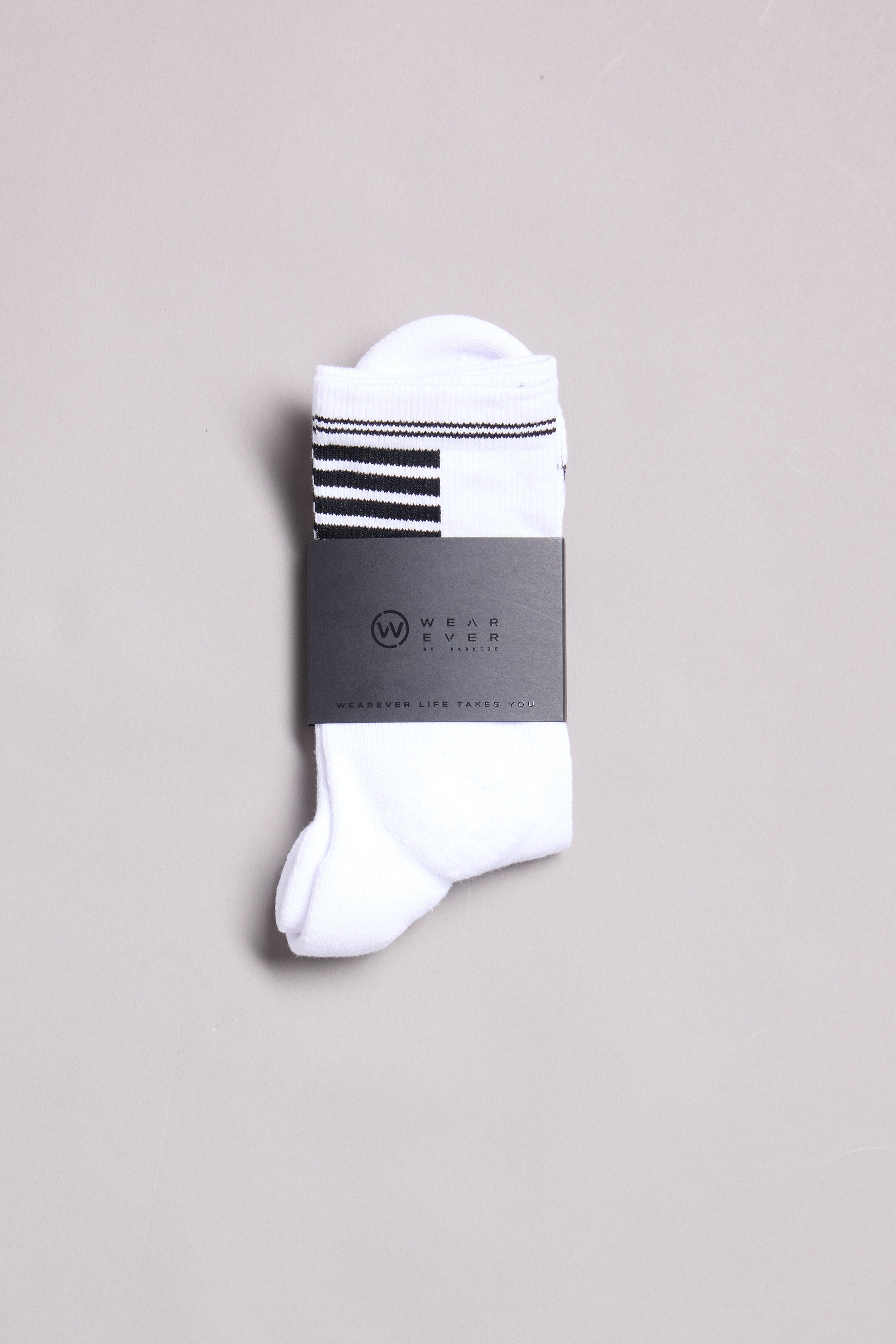 A pair of white WearEver Active Socks with black stripes near the top, neatly folded with a black WearEver label, is displayed on a light gray background. Made in New Zealand, these socks offer moisture-wicking comfort.