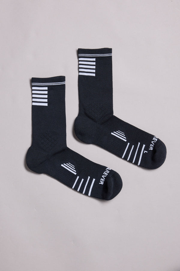 A pair of black WearEver Active Socks by WearEver with white stripes near the cuffs and toes, “FEVER” text, and “L” and “R” markings, laid flat on a light gray background.