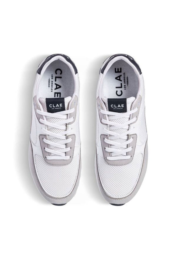 A top view of the Clae - Joshua by Clae shows white and light gray sustainable sneakers with mesh uppers, gray suede accents, white laces, and black branding on the tongue and insole.