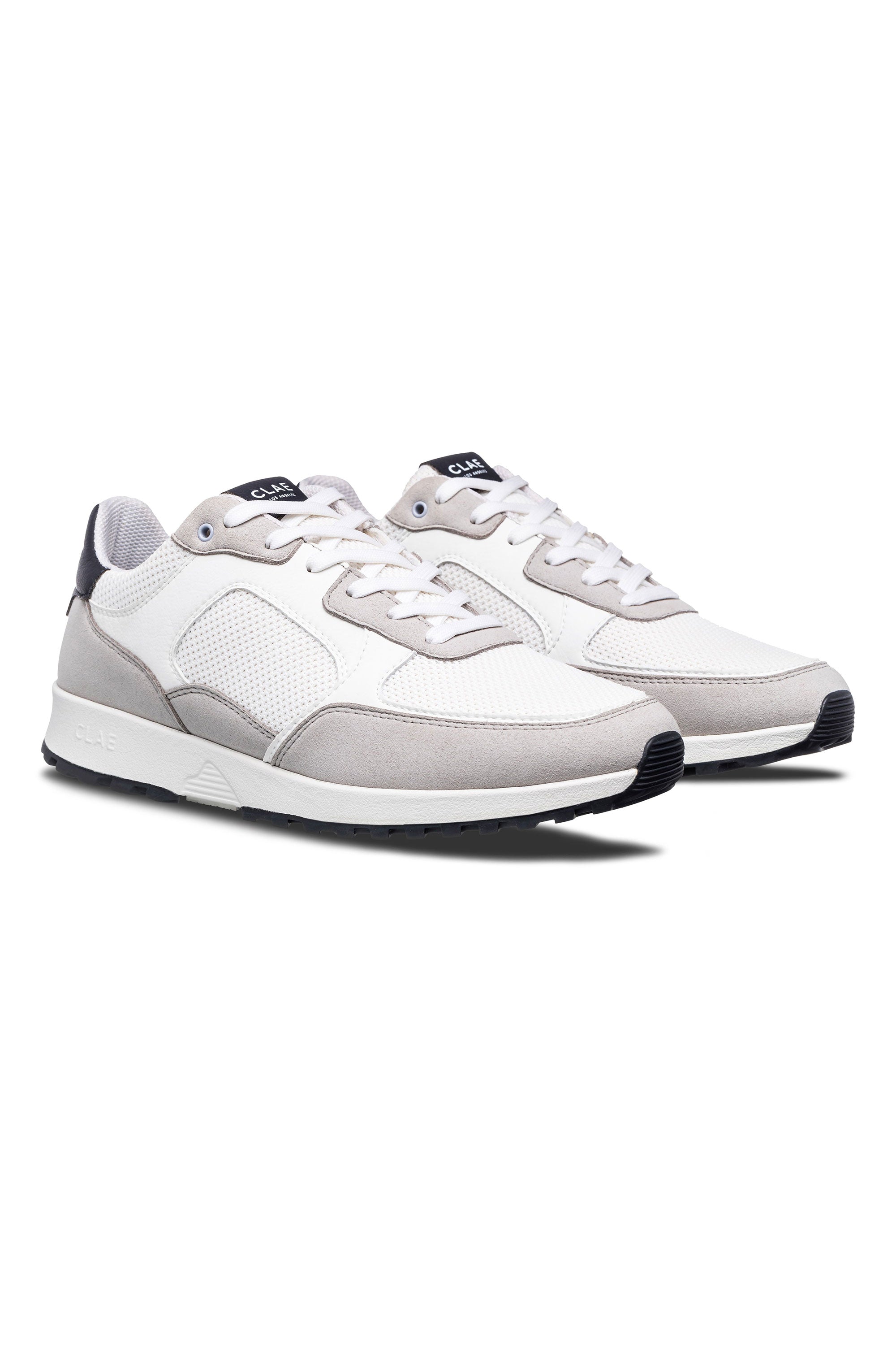 The Clae Joshua sneakers by Clae, featuring white and light gray sustainable materials, mesh panels, suede accents, and white laces, are displayed side by side on a white background.